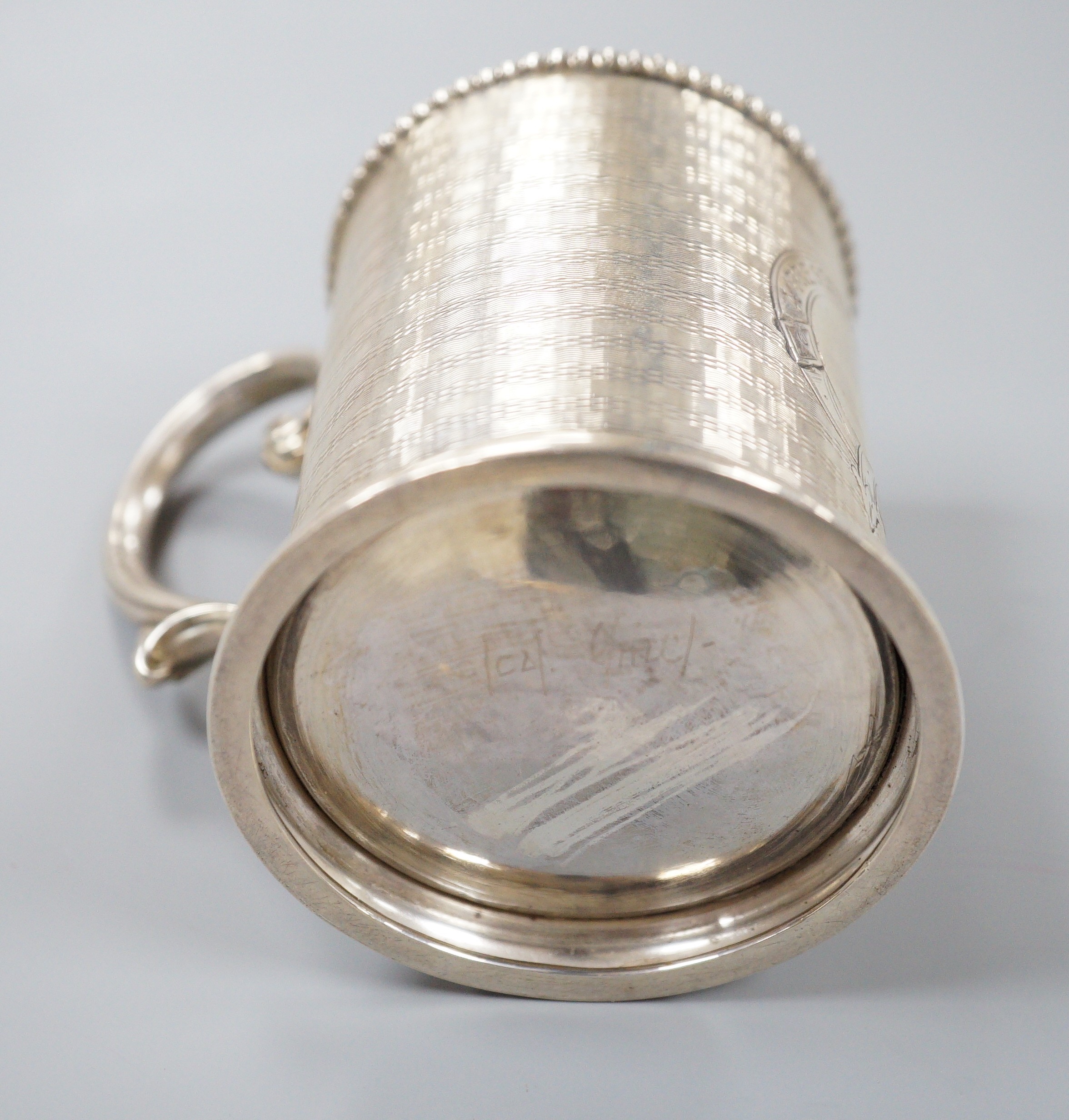 A Victorian engine turned silver christening mug, with engraved inscription, George Unite, Birmingham, 1868, 86mm.